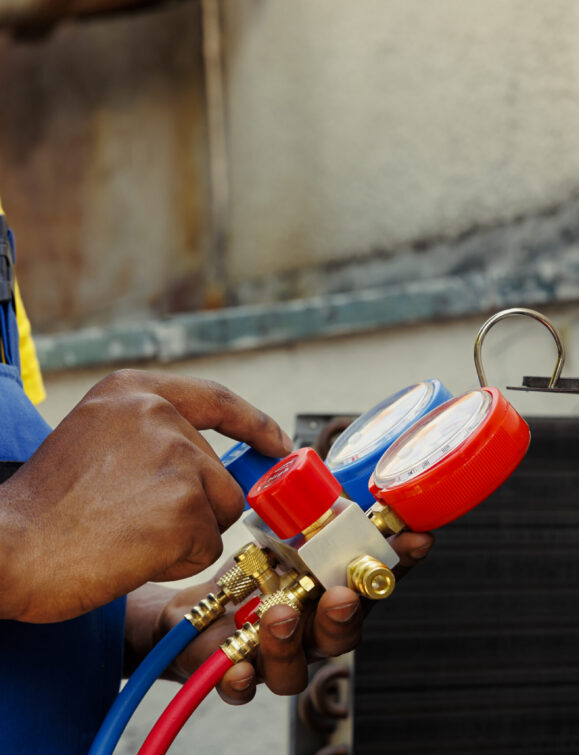 Close up of manometers able to detect hvac system moisture intrusion, refrigerant not circulating and other issues. Trained engineer using barometer set to read air conditioner pressure levels